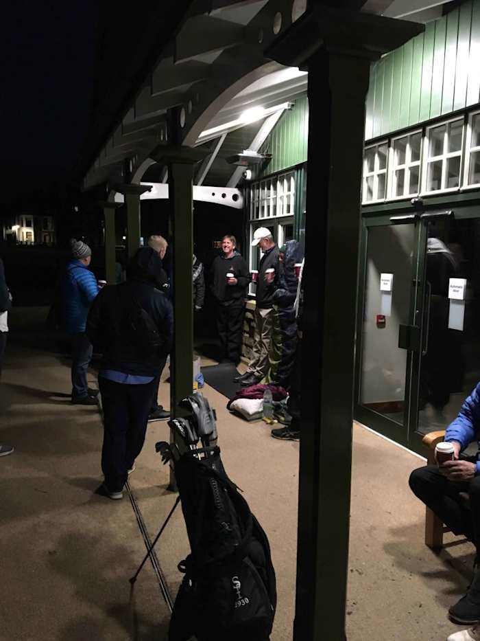 Golfers waiting out single spots on The Old Course in St. Andrews, Scotland, share coffee and stories.